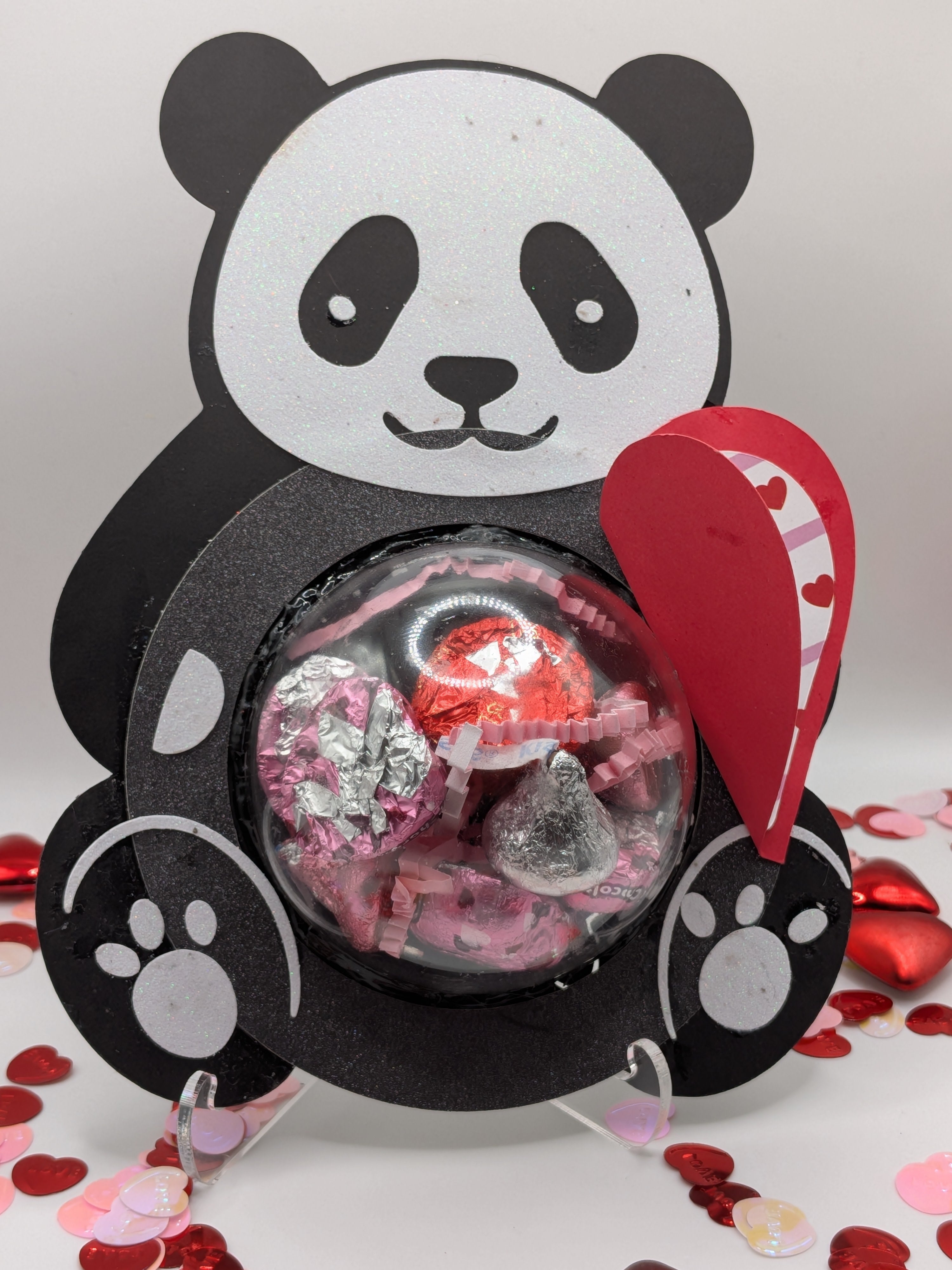 Panda-shaped valentine with a red heart note card and candy inside.